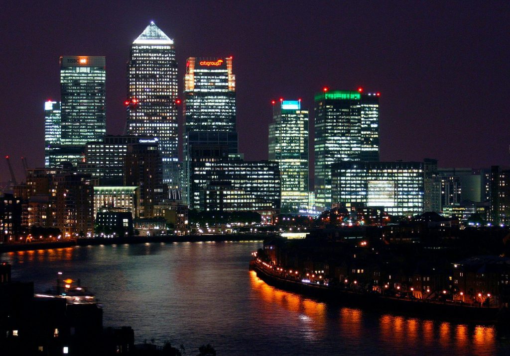Beautiful nighttime view of Canary Wharf, London, with reflections on the River Thames.
